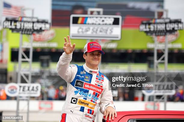 Harrison Burton, driver of the Motorcraft/DEX Imaging Ford, waves to fans during a parade lap prior to the NASCAR Cup Series All-Star Open at Texas...