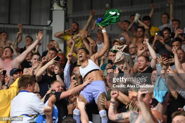 Raphinha of Leeds United celebrates with the fans after avoiding relegation following victory in the Premier League match between Brentford and Leeds...