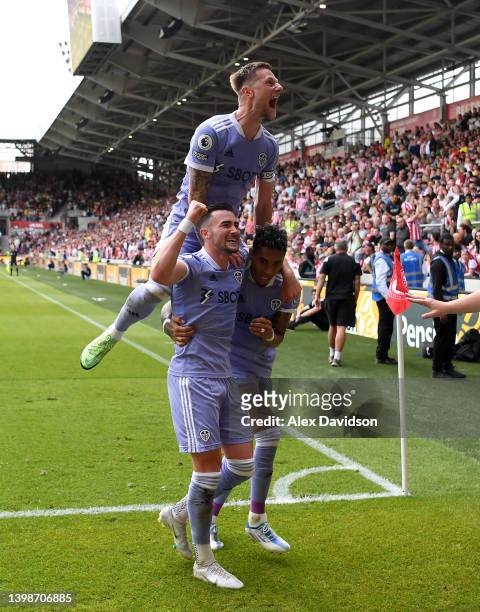 Jack Harrison of Leeds United celebrates with teammates Liam Cooper and Raphinha after scoring their side's second goal during the Premier League...