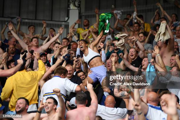 Raphinha of Leeds United celebrates with the fans after avoiding relegation following victory in the Premier League match between Brentford and Leeds...