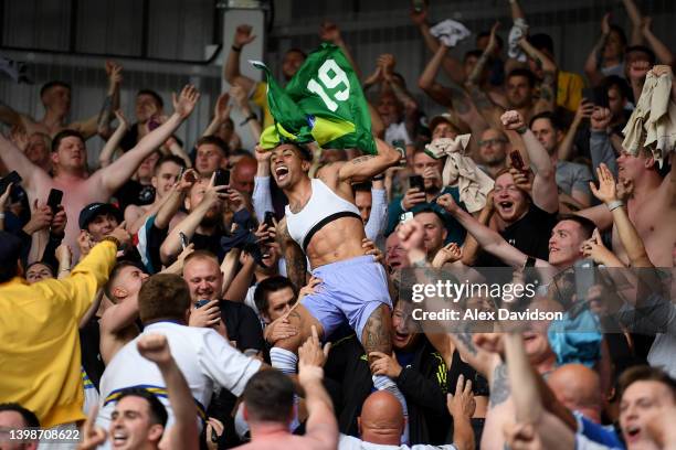 Raphinha of Leeds United celebrates with the fans after avoiding relegation following victory in the Premier League match between Brentford and Leeds...