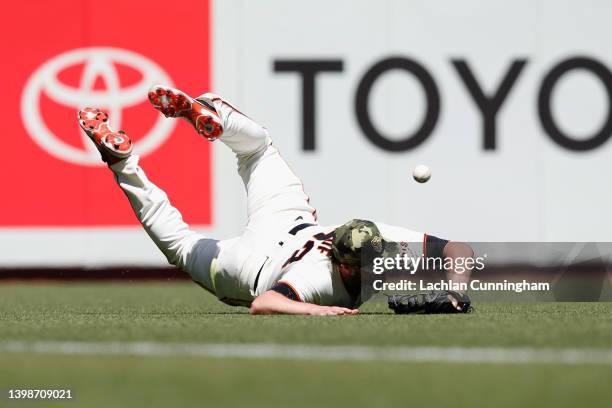 Darin Ruf of the San Francisco Giants is unable to catch a fly ball hit by Luke Voit of the San Diego Padres in the top of the sixth inning at Oracle...