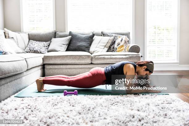 woman exercising at home - plank stock pictures, royalty-free photos & images