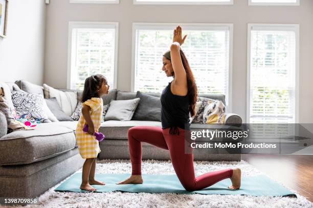 mother and toddler daughter exercising at home - girl in yellow dress stock pictures, royalty-free photos & images