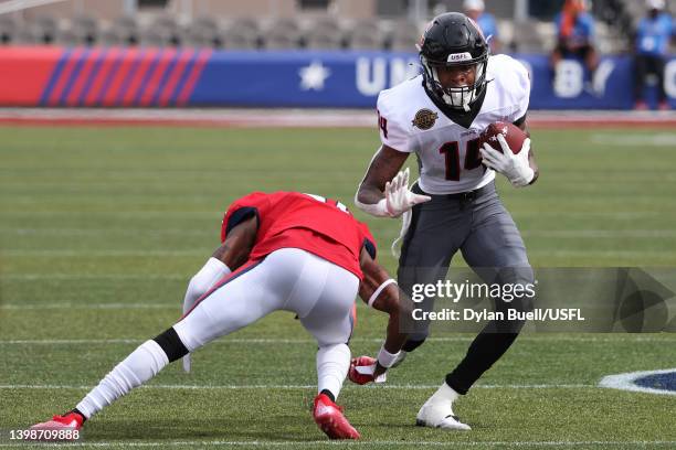 Teo Redding of the Houston Gamblers runs with the ball as De'Vante Bausby of the New Jersey Generals defends in the second quarter of the game at...