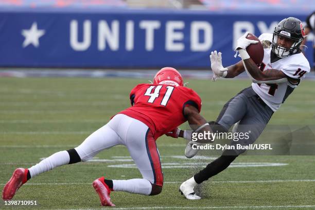 Teo Redding of the Houston Gamblers runs with the ball as De'Vante Bausby of the New Jersey Generals defends in the fourth quarter of the game at...
