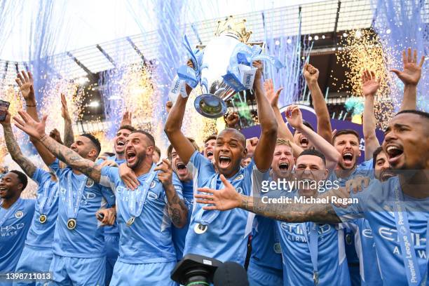 Fernandinho of Manchester City lifts the Premier League trophy with team mates Riyad Mahrez, Kyle Walker, Phil Foden, Kevin De Bruyne, Ruben Diaz and...