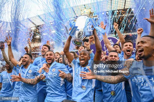 Fernandinho of Manchester City lifts the Premier League trophy with team mates Riyad Mahrez, Kyle Walker, Phil Foden, Kevin De Bruyne, Ruben Diaz and...