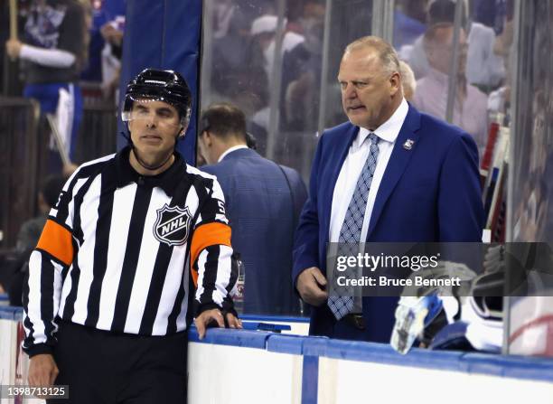 Head coach Gerard Gallant of the New York Rangers talks to referee Chris Rooney following a 3-1 victory over the Carolina Hurricanes in Game Three of...