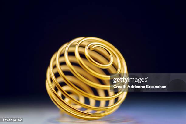 small metal spiral cage ornament - gold circle 3d stock pictures, royalty-free photos & images