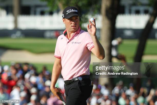 Justin Thomas of the United States reacts to his birdie putt on the 17th green, the second playoff hole during the final round of the 2022 PGA...