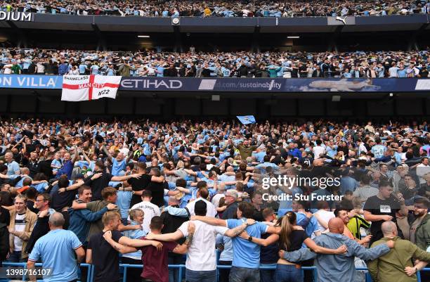 Manchester City fans celebrate winning the Premier League title by doing the Poznan celebration after the Premier League match between Manchester...