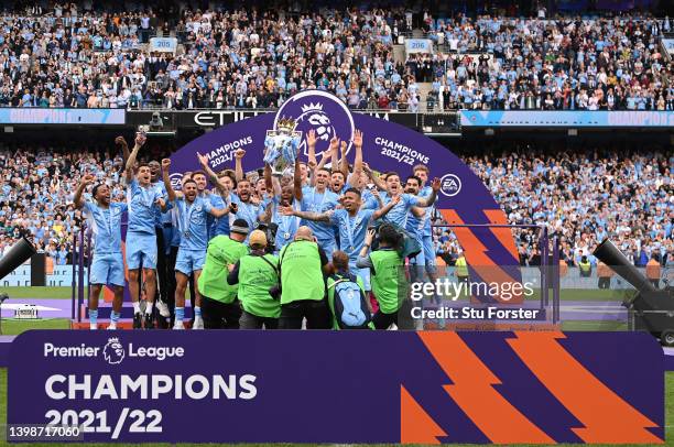 Manchester City captain Fernandinho lifts the Premier League Trophy and celebrates with the squad after the Premier League match between Manchester...