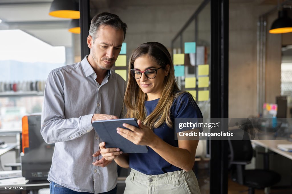 Business team working online at the office using a tablet
