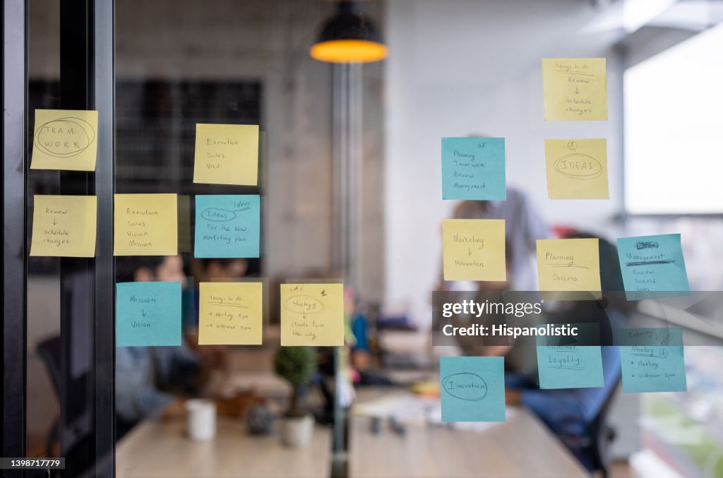 Business strategy written on a board using post its