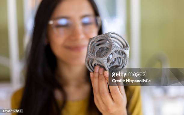 close-up on a designer holding a 3d printed model - 3d human model stock pictures, royalty-free photos & images