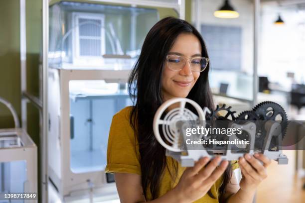 designer holding a 3d printed model at a creative studio - model object stock pictures, royalty-free photos & images