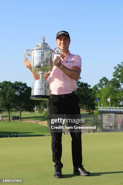 Justin Thomas of the United States poses with the Wanamaker Trophy after putting in to win on the 18th green, the third playoff hole during the final...