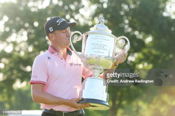 Justin Thomas of the United States poses with the Wanamaker Trophy after putting in to win on the 18th green, the third playoff hole during the final...
