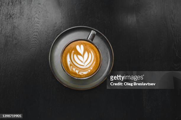 coffee cup on dark wooden background. copy space and minimalist style - coffee art stockfoto's en -beelden