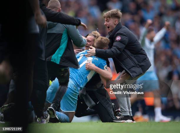 Kevin De Bruyne of Manchester City is mobbed by fans after the Premier League match between Manchester City and Aston Villa at Etihad Stadium on May...