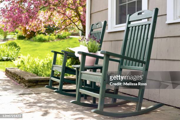 rocking chairs and pot of lavender. - front porch no people stock pictures, royalty-free photos & images