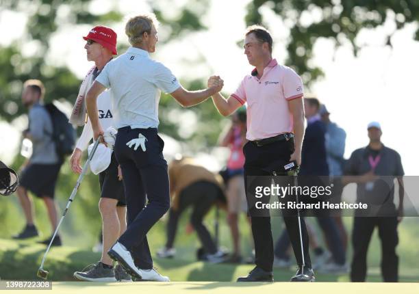 Justin Thomas of the United States shakes hands with Will Zalatoris of the United States on the 18th green, the third playoff hole during the final...