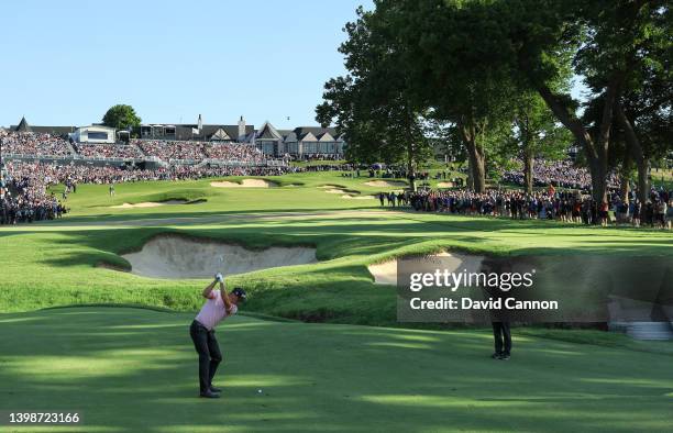Justin Thomas of The United States prepares to play his second shot on the 18th hole the third hole of the sudden-death play-off with Will Zalatoris...
