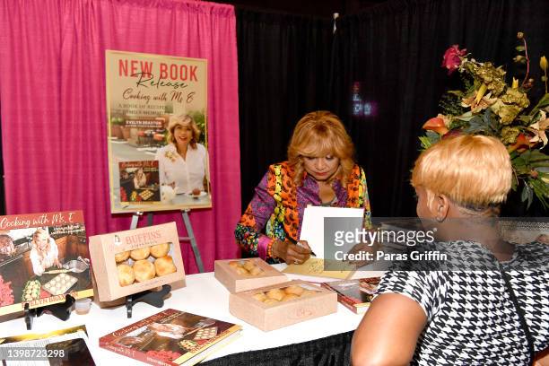 Personality/author Evelyn Braxton signs copies of her cookbook "Cooking with Ms. E" during day 2 of the 2022 Atlanta Ultimate Women's Expo at Cobb...