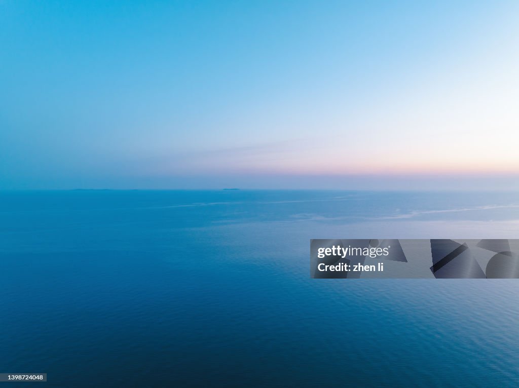 Aerial view of sea at sunrise
