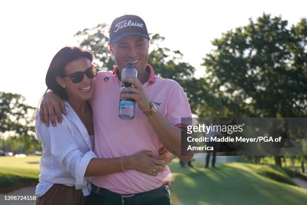 Justin Thomas of the United States hugs his fiance Jillian Wisniewski after his winning putt on the 18th hole, the third playoff hole with his fiance...