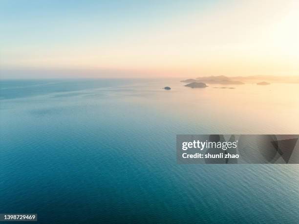 aerial view of sea at sunrise - 日の出　海 ストックフォトと画像