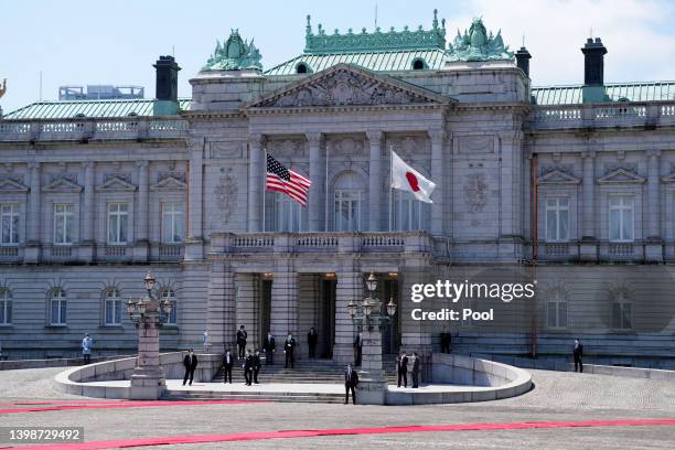 Security guards are seen while national flags of the United States and Japan are hoisted before the welcome ceremony for U.S. President Joe...