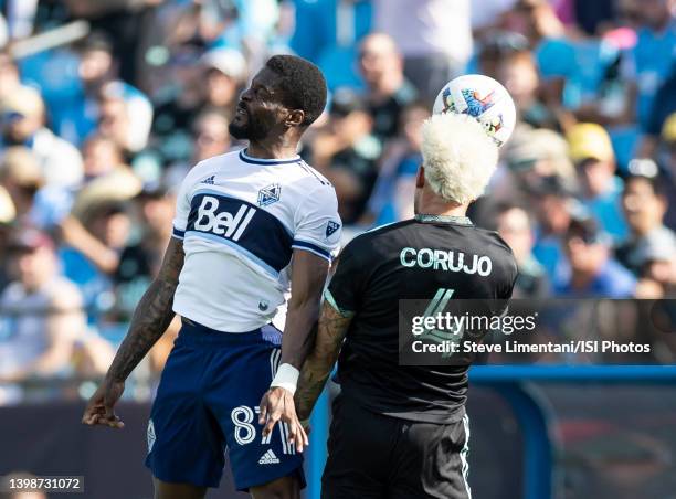 Tosaint Ricketts of Vancouver Whitecaps and Guzmán Corujo of Charlotte FC go for a header during the game between the Vancouver Whitecaps and...