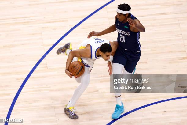 Jordan Poole of the Golden State Warriors drives past Frank Ntilikina of the Dallas Mavericks during the first quarter in Game Three of the 2022 NBA...