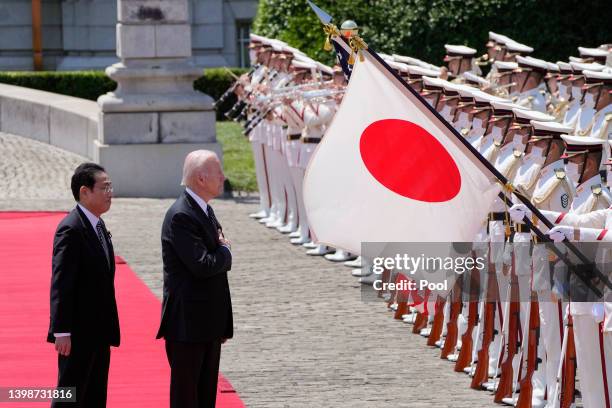 President Joe Biden reviews an honour guard with Japanese Prime Minister Fumio Kishida during a welcome ceremony for President Biden at the Akasaka...