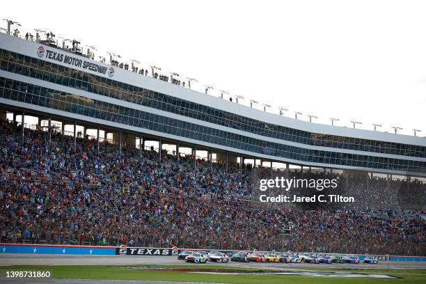 Kyle Busch, driver of the M&M's Crunchy Cookie Toyota, leads the field to start the NASCAR Cup Series All-Star Race at Texas Motor Speedway on May...