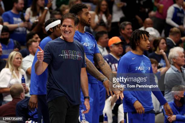Dallas Mavericks owner Mark Cuban celebrates a three point basket during the second quarter against the Golden State Warriors in Game Three of the...