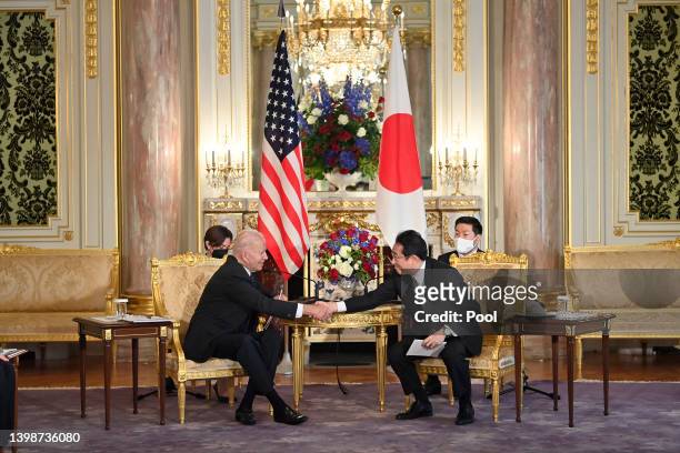 President Joe Biden and Japanese Prime Minister Fumio Kishida shake hands during the Japan-US summit meeting at Akasaka State Guest House on May 23,...