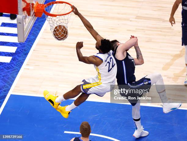 Andrew Wiggins of the Golden State Warriors dunks the ball against Luka Doncic of the Dallas Mavericks during the fourth quarter in Game Three of the...