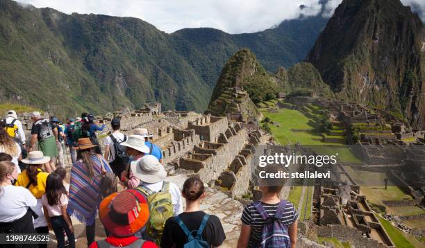 touristen in machu picchu , peru - berg huayna picchu stock-fotos und bilder