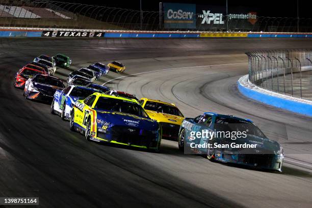 Ryan Blaney, driver of the Menards/Wrangler Ford, and Austin Cindric, driver of the Keystone Light Ford, race during the NASCAR Cup Series All-Star...