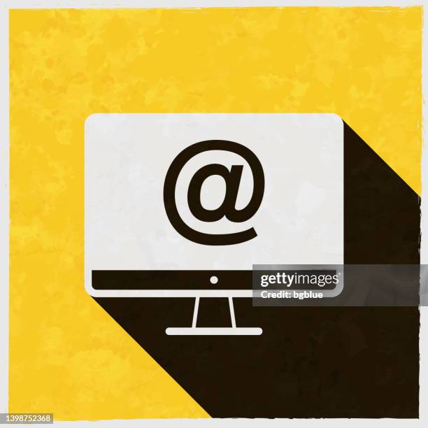 desktop computer with at symbol. icon with long shadow on textured yellow background - tv screen texture stock illustrations