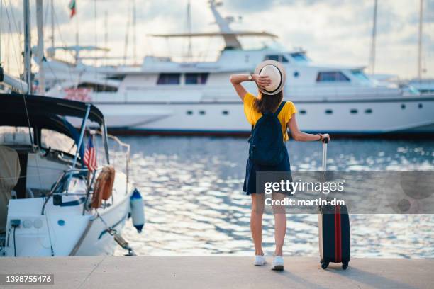 woman at the marina ready for sailing with yacht - pier sunset imagens e fotografias de stock