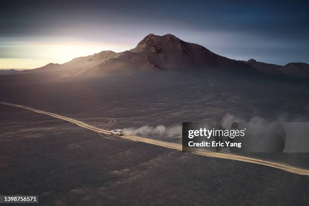 driving on desert road - country roads stock-fotos und bilder