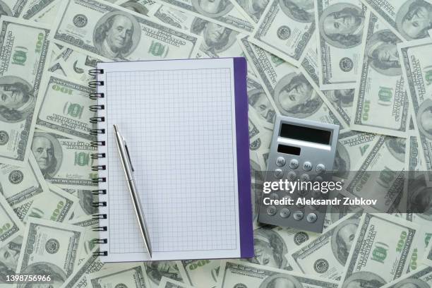 calculator, pen, notepad and dollar bills. the concept of financial accounting, calculation of business profit or loss, management of expenses and income.  investing, business and the global crisis. lending and insurance. salary, bribe or credit funds. - tax penalty stock pictures, royalty-free photos & images