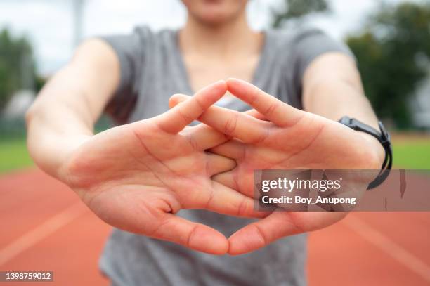 close up of woman stretching hands with crossed fingers before workout or sport training. - person with arms crossed stock pictures, royalty-free photos & images