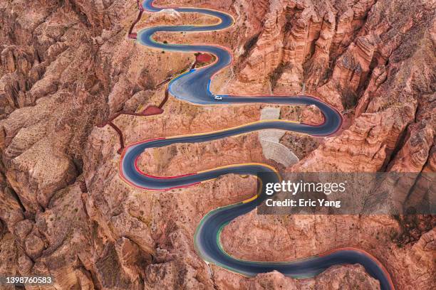 winding road through mountain - mountain road stock pictures, royalty-free photos & images