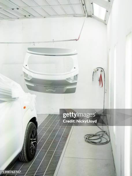 car inside the painting booth of auto repair shop - motorvoertuig stockfoto's en -beelden