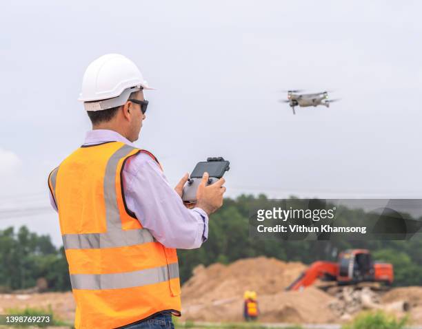 surveyor and drone for survey  on construction site, land and soil development, survey equipment,civil engineer. - aerial surveillance stock pictures, royalty-free photos & images